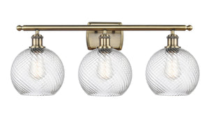 516-3W-AB-G1214-8 3-Light 26" Antique Brass Bath Vanity Light - Clear Athens Twisted Swirl 8" Glass - LED Bulb - Dimmensions: 26 x 9 x 13 - Glass Up or Down: Yes