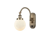 1-Light 6" Antique Brass Sconce - Matte White Cased Beacon Glass LED