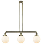 213-AB-G201-8 3-Light 40.5" Antique Brass Island Light - Matte White Cased Beacon Glass - LED Bulb - Dimmensions: 40.5 x 8 x 12.875<br>Minimum Height : 22<br>Maximum Height : 46 - Sloped Ceiling Compatible: Yes