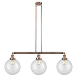 213-AC-G202-10 3-Light 42" Antique Copper Island Light - Clear Beacon Glass - LED Bulb - Dimmensions: 42 x 10 x 14<br>Minimum Height : 24<br>Maximum Height : 48 - Sloped Ceiling Compatible: Yes
