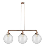 213-AC-G204-12 3-Light 44" Antique Copper Island Light - Seedy Beacon Glass - LED Bulb - Dimmensions: 44 x 12 x 16<br>Minimum Height : 26<br>Maximum Height : 50 - Sloped Ceiling Compatible: Yes