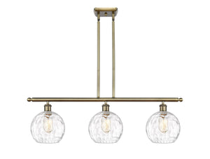 516-3I-AB-G1215-8 3-Light 36" Antique Brass Island Light - Clear Athens Water Glass 8" Glass - LED Bulb - Dimmensions: 36 x 8 x 11<br>Minimum Height : 20.375<br>Maximum Height : 44.375 - Sloped Ceiling Compatible: Yes