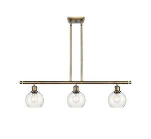 516-3I-AB-G124-6 3-Light 36" Antique Brass Island Light - Seedy Athens Glass - LED Bulb - Dimmensions: 36 x 6 x 9.375<br>Minimum Height : 18.375<br>Maximum Height : 42.375 - Sloped Ceiling Compatible: Yes