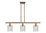 516-3I-BB-G112 3-Light 36" Brushed Brass Island Light - Clear Cobbleskill Glass - LED Bulb - Dimmensions: 36 x 5 x 10<br>Minimum Height : 19.375<br>Maximum Height : 43.375 - Sloped Ceiling Compatible: Yes