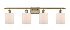 4-Light 36" Antique Brass Bath Vanity Light - Matte White Cobbleskill Glass LED