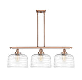 916-3I-AC-G713-L 3-Light 36" Antique Copper Island Light - Clear Deco Swirl X-Large Bell Glass - LED Bulb - Dimmensions: 36 x 8 x 11<br>Minimum Height : 20.375<br>Maximum Height : 44.375 - Sloped Ceiling Compatible: Yes