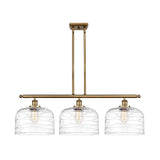 916-3I-BB-G713-L 3-Light 36" Brushed Brass Island Light - Clear Deco Swirl X-Large Bell Glass - LED Bulb - Dimmensions: 36 x 8 x 11<br>Minimum Height : 20.375<br>Maximum Height : 44.375 - Sloped Ceiling Compatible: Yes